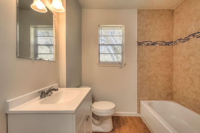 full bath featuring plenty of natural light, vanity, toilet, and wood finished floors