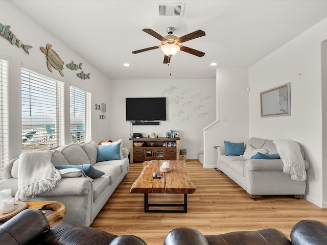 living area with ceiling fan, recessed lighting, visible vents, and light wood-style flooring