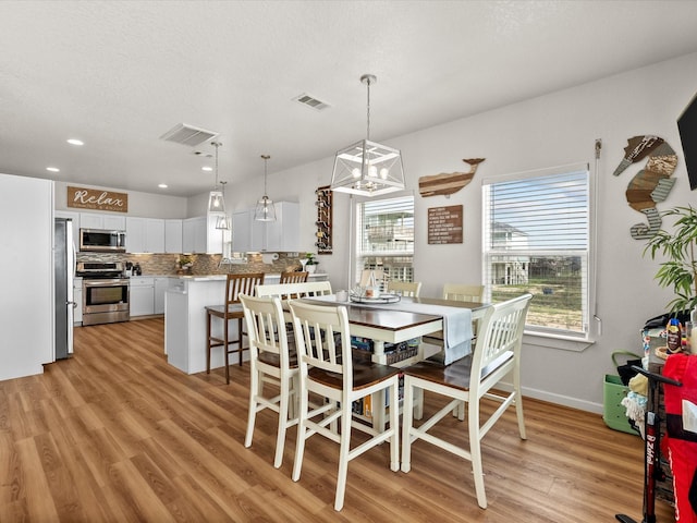 dining room featuring visible vents, recessed lighting, and light wood-style floors