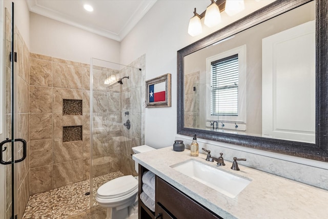 full bathroom featuring toilet, ornamental molding, vanity, and a stall shower