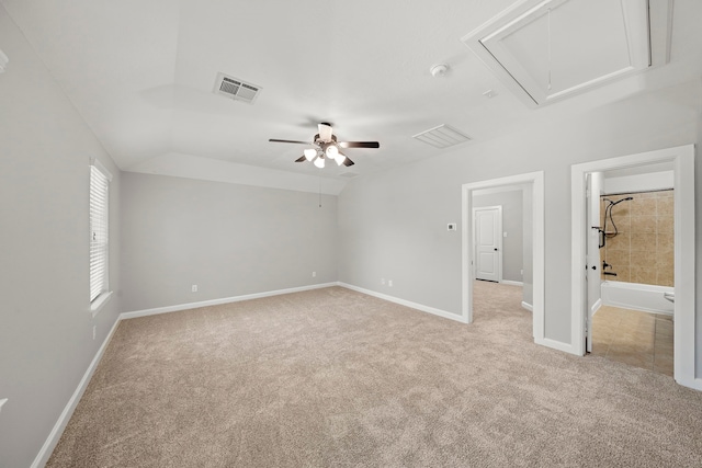 interior space with visible vents, baseboards, attic access, and light colored carpet