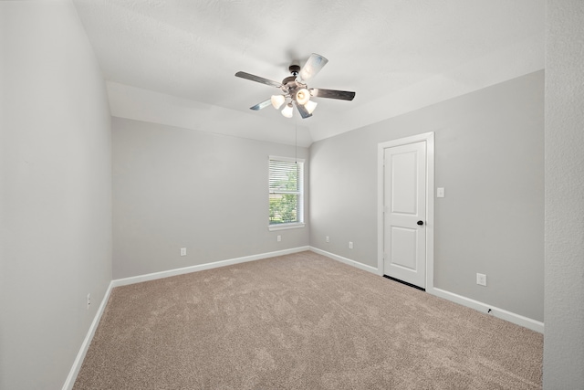 carpeted empty room with ceiling fan and baseboards