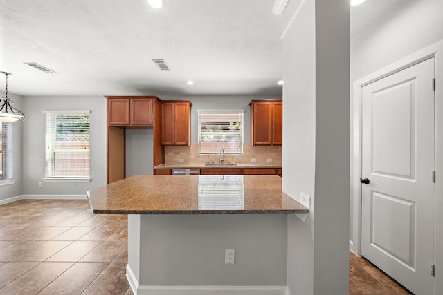 kitchen featuring visible vents, baseboards, and a healthy amount of sunlight