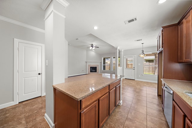 kitchen featuring baseboards, dishwasher, decorative columns, brown cabinetry, and light tile patterned flooring