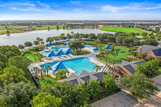 community pool with a water view and a patio area