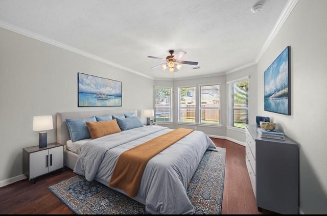bedroom featuring crown molding, dark wood-style flooring, and baseboards