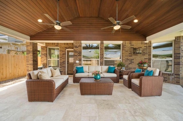view of patio with an outdoor living space, ceiling fan, and fence