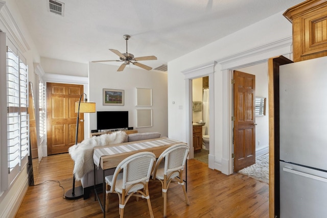 6114 Truro St, Houston, TX 77007 - dining space featuring light wood-type flooring, ceiling fan, baseboards, and visible vents