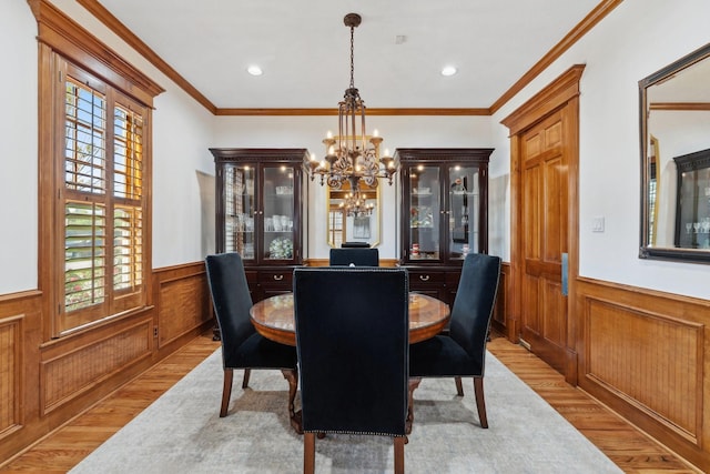 6114 Truro St, Houston, TX 77007 - dining space featuring light wood-style floors, wainscoting, and a chandelier