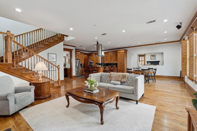 6114 Truro St, Houston, TX 77007 - living area featuring ornamental molding, visible vents, baseboards, and recessed lighting