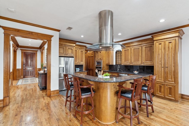 6114 Truro St, Houston, TX 77007 - kitchen with crown molding, island exhaust hood, and stainless steel appliances