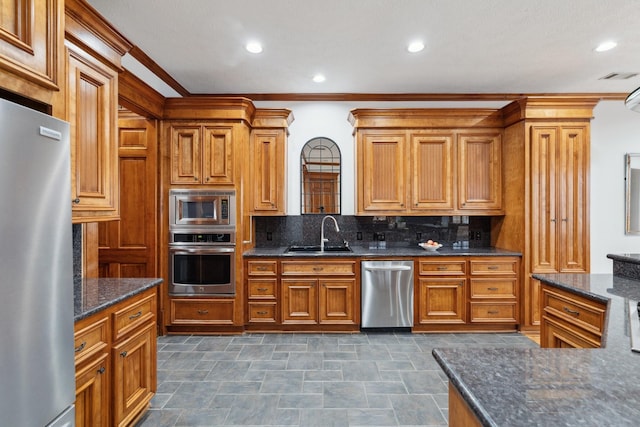 6114 Truro St, Houston, TX 77007 - kitchen with ornamental molding, visible vents, appliances with stainless steel finishes, a sink, and backsplash