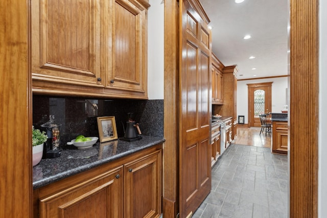 6114 Truro St, Houston, TX 77007 - kitchen featuring tasteful backsplash, ornamental molding, recessed lighting, brown cabinetry, and stone tile floors