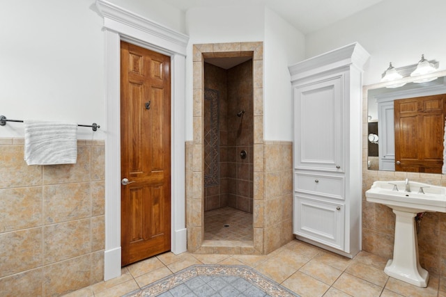 6114 Truro St, Houston, TX 77007 - full bath with tiled shower, a wainscoted wall, a sink, tile walls, and tile patterned floors