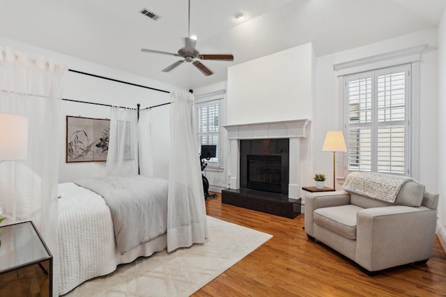 6114 Truro St, Houston, TX 77007 - bedroom featuring visible vents, a ceiling fan, wood finished floors, and a fireplace