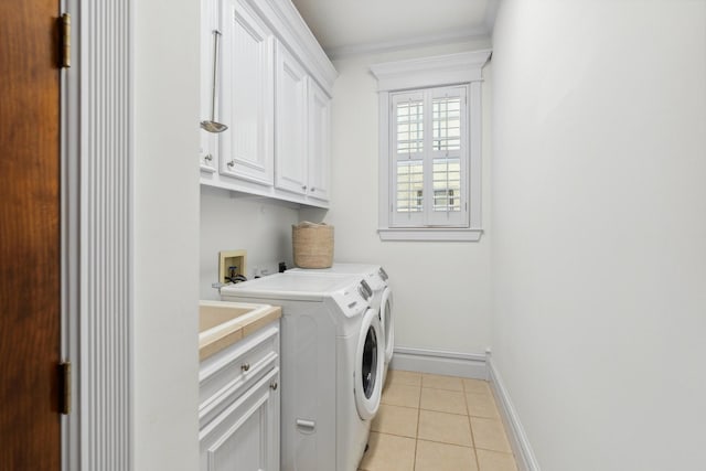 6114 Truro St, Houston, TX 77007 - laundry area featuring light tile patterned floors, baseboards, ornamental molding, independent washer and dryer, and cabinet space