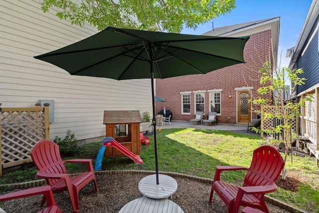 6114 Truro St, Houston, TX 77007 - exterior space with fence, a patio area, a playground, and a lawn