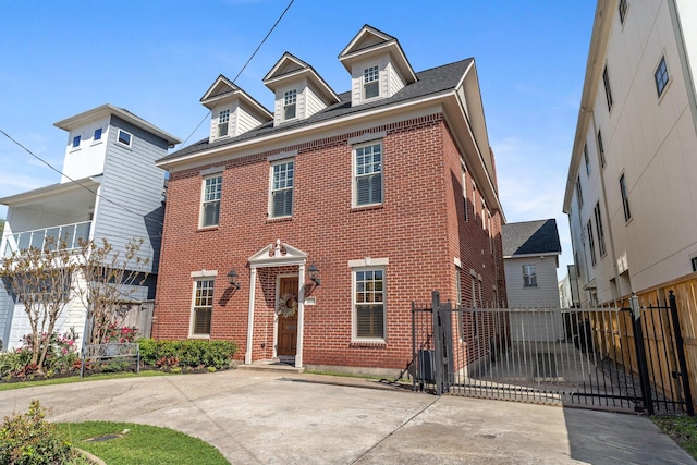 6114 Truro St, Houston, TX 77007 - view of front facade with brick siding, fence, and a gate