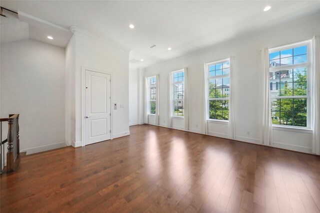unfurnished living room featuring wood finished floors, recessed lighting, crown molding, and baseboards