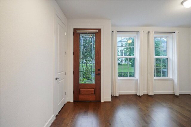entryway with dark wood-style flooring and baseboards