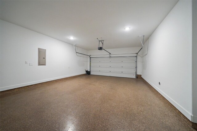 garage with baseboards, recessed lighting, a garage door opener, and electric panel