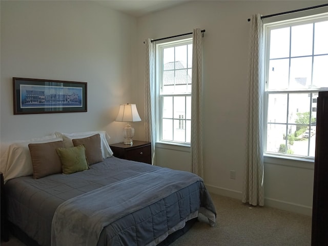 bedroom with carpet flooring and baseboards