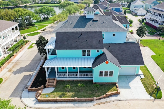 birds eye view of property featuring a water view and a residential view