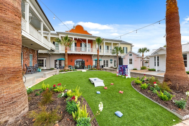 exterior space featuring french doors, a patio area, and a balcony