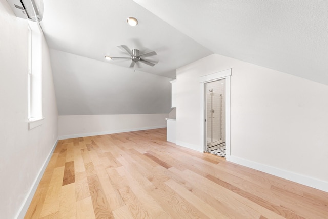 13 Caravelle Ct, Galveston, TX 77554 - bonus room featuring a wall mounted air conditioner, vaulted ceiling, light wood-style floors, and ceiling fan