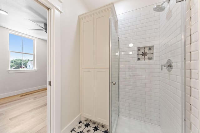 13 Caravelle Ct, Galveston, TX 77554 - full bathroom featuring a shower stall, a ceiling fan, and wood finished floors