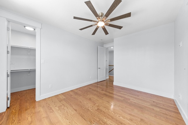 13 Caravelle Ct, Galveston, TX 77554 - unfurnished bedroom with a spacious closet, light wood-style floors, a ceiling fan, and a closet
