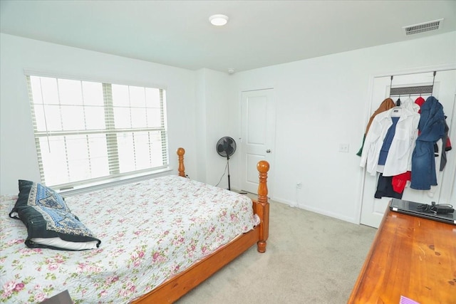 17014 Wild Stream Ct, Conroe, TX 77302 - bedroom featuring a closet, visible vents, light colored carpet, and baseboards