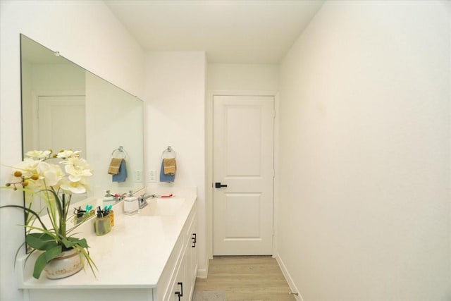 17014 Wild Stream Ct, Conroe, TX 77302 - bathroom with wood finished floors, vanity, and baseboards