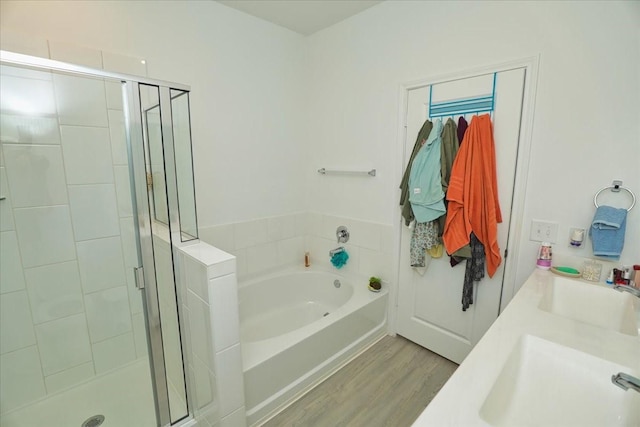 17014 Wild Stream Ct, Conroe, TX 77302 - bathroom featuring a bath, a sink, wood finished floors, and a stall shower