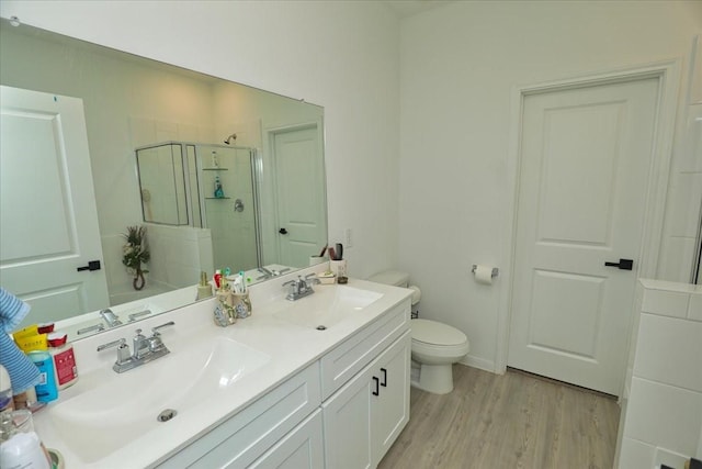 17014 Wild Stream Ct, Conroe, TX 77302 - full bath featuring a stall shower, wood finished floors, double vanity, and a sink