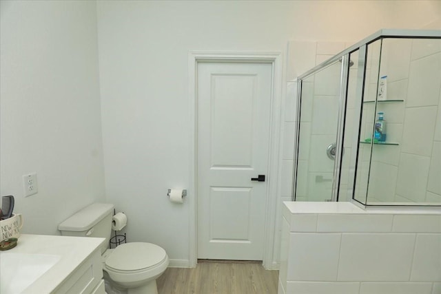 17014 Wild Stream Ct, Conroe, TX 77302 - bathroom with vanity, toilet, a stall shower, baseboards, and wood finished floors