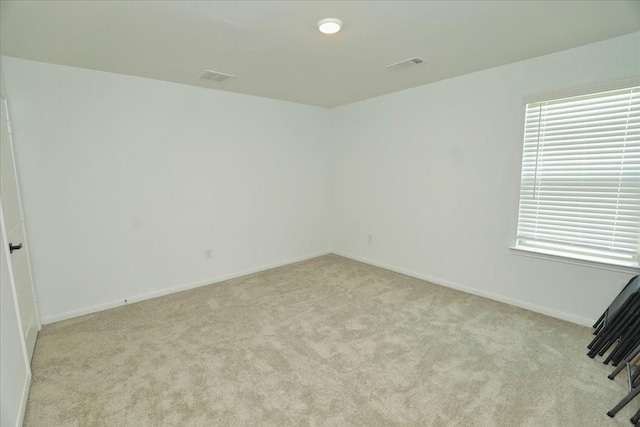17014 Wild Stream Ct, Conroe, TX 77302 - empty room featuring carpet, a wealth of natural light, and baseboards