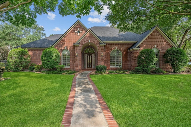 8802 Kennet Valley Rd, Spring, TX 77379 - view of front of house featuring brick siding, roof with shingles, and a front lawn