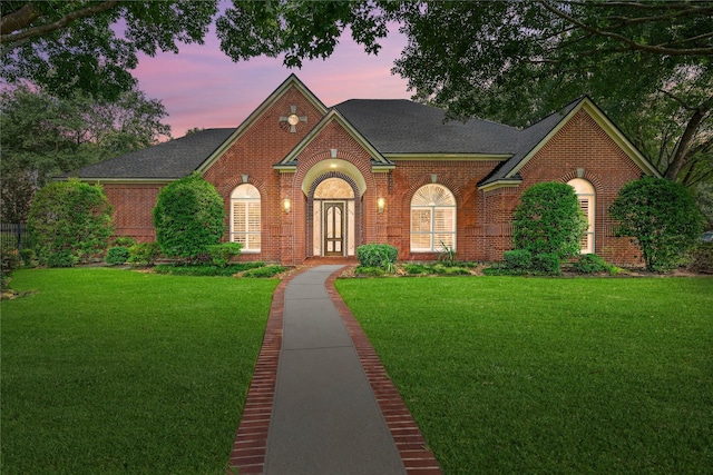 8802 Kennet Valley Rd, Spring, TX 77379 - view of front of house with brick siding, a front lawn, and a shingled roof