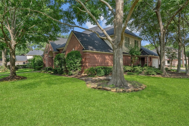 8802 Kennet Valley Rd, Spring, TX 77379 - view of home's exterior featuring brick siding, a lawn, and a shingled roof