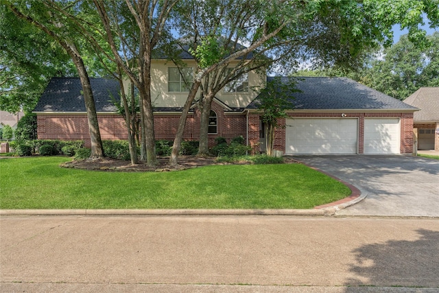 8802 Kennet Valley Rd, Spring, TX 77379 - view of front facade featuring brick siding, driveway, an attached garage, and a front yard
