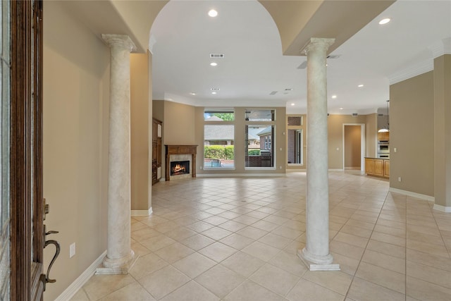8802 Kennet Valley Rd, Spring, TX 77379 - foyer entrance featuring ornate columns, recessed lighting, light tile patterned flooring, ornamental molding, and a warm lit fireplace