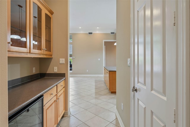 8802 Kennet Valley Rd, Spring, TX 77379 - kitchen featuring wine cooler, light tile patterned flooring, dark countertops, glass insert cabinets, and baseboards
