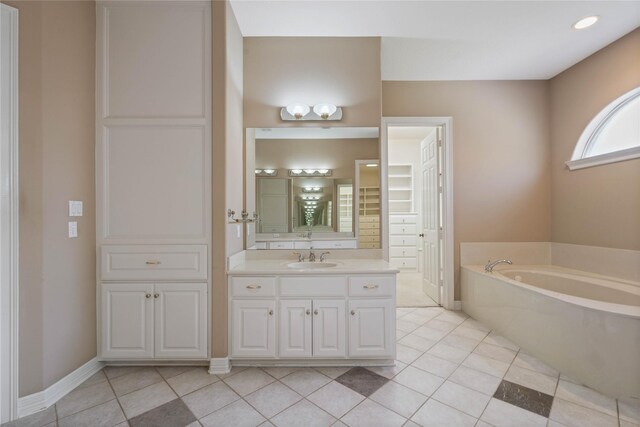 8802 Kennet Valley Rd, Spring, TX 77379 - bathroom with a bath, vanity, tile patterned floors, and baseboards