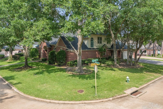 8802 Kennet Valley Rd, Spring, TX 77379 - view of front of house with brick siding, a front yard, and driveway