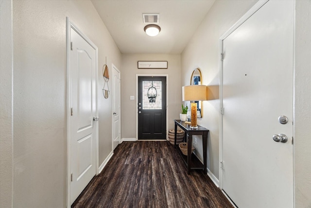 doorway to outside featuring baseboards, wood finished floors, and visible vents