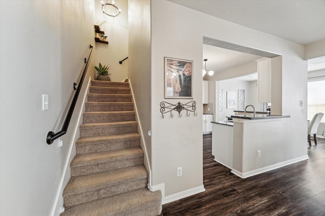 staircase with baseboards and wood finished floors