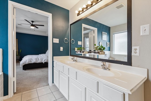 ensuite bathroom featuring ceiling fan, visible vents, a sink, and tile patterned flooring