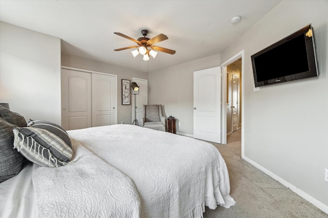 carpeted bedroom with a ceiling fan, baseboards, and a closet
