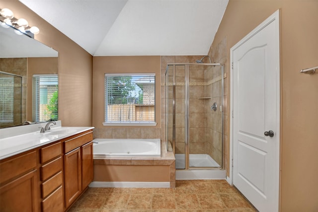 full bathroom with a shower stall, a healthy amount of sunlight, lofted ceiling, and vanity